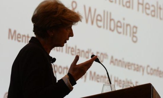 A woman speaking at a presentation
