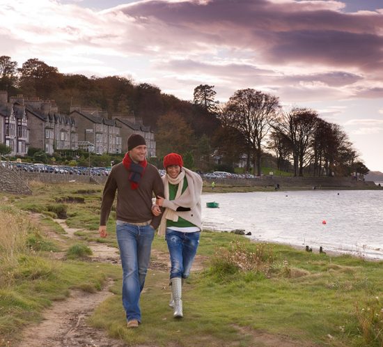 A couple walking along the sea-shore