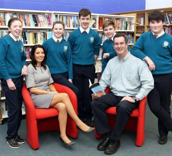 Two teachers with students in a library