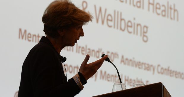 A woman speaking at a presentation